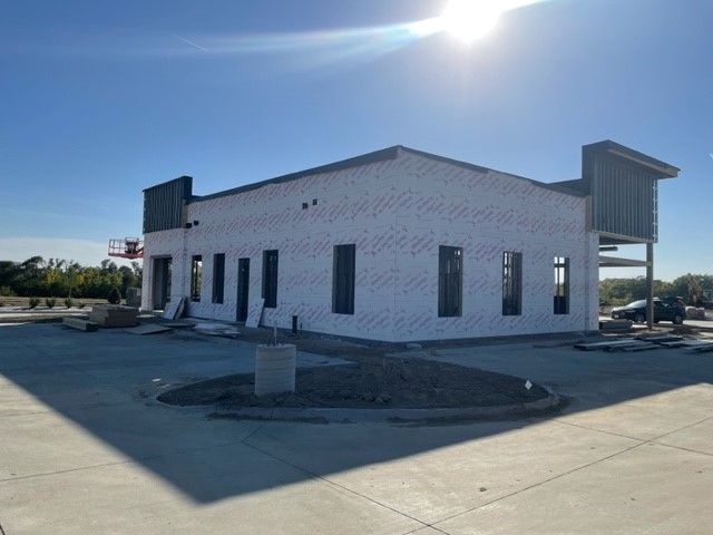 A white building with a lot of windows is being built
