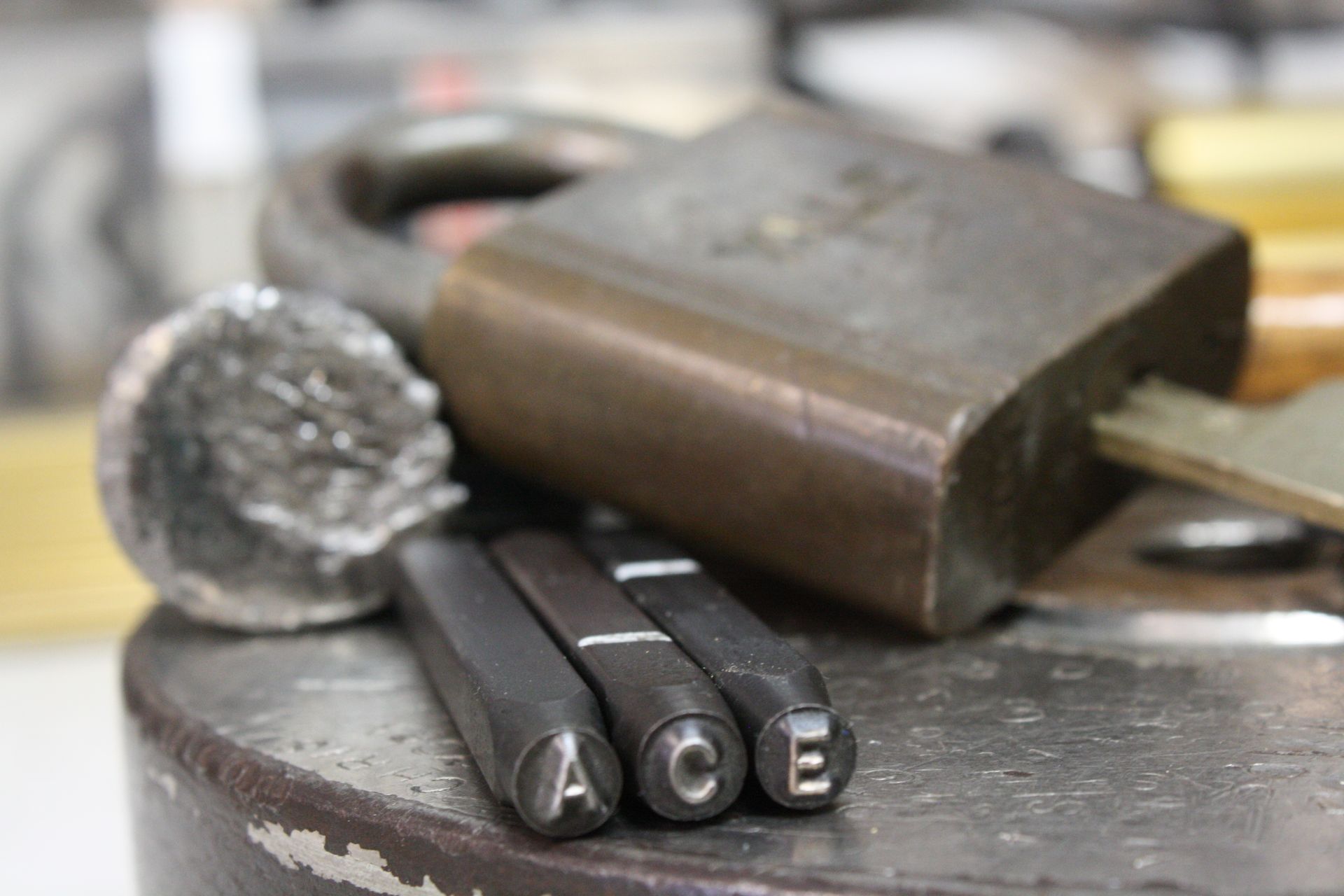Close-up of metal stamp tools spelling 