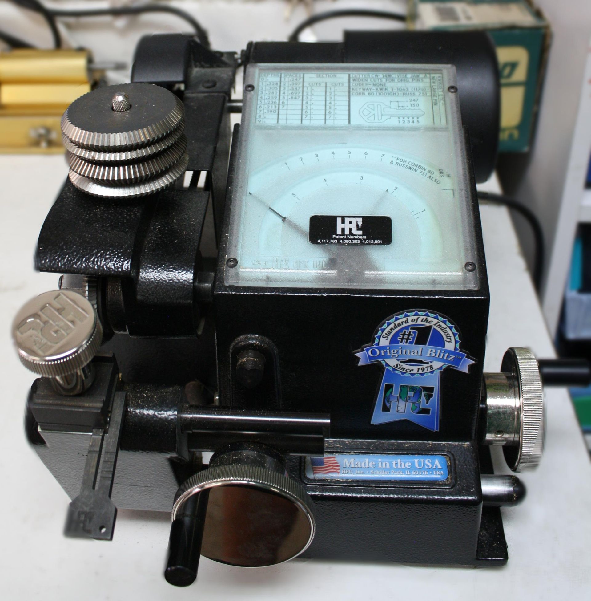 Black and silver engraving machine with gauges and knobs; HRC brand.