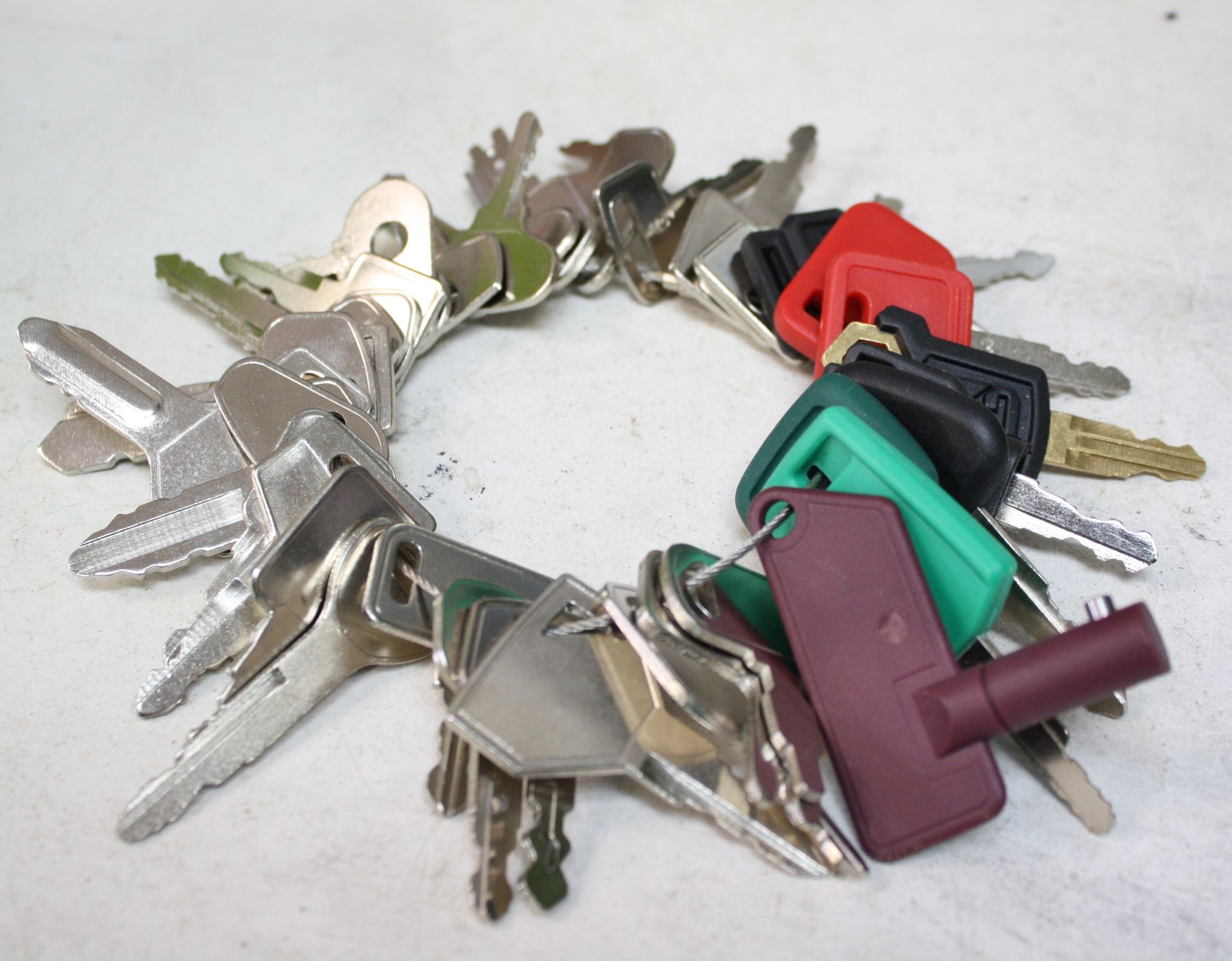 A circular cluster of various keys, many with colorful plastic heads.