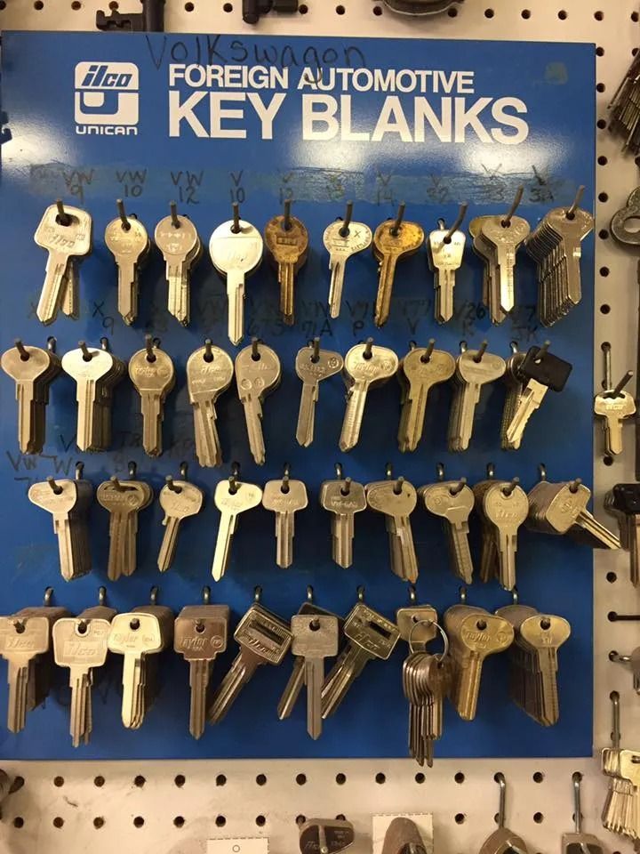 Blue board displaying rows of foreign automotive key blanks, likely for a locksmith shop.