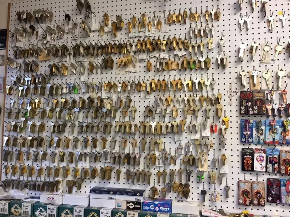 Wall covered with various keys in a locksmith shop, showcasing an extensive selection for duplication.