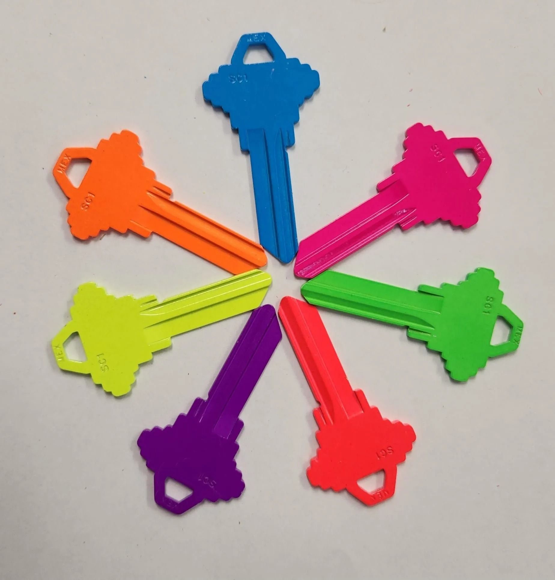 Seven brightly colored keys arranged in a circle: orange, blue, pink, green, purple, red, and yellow.