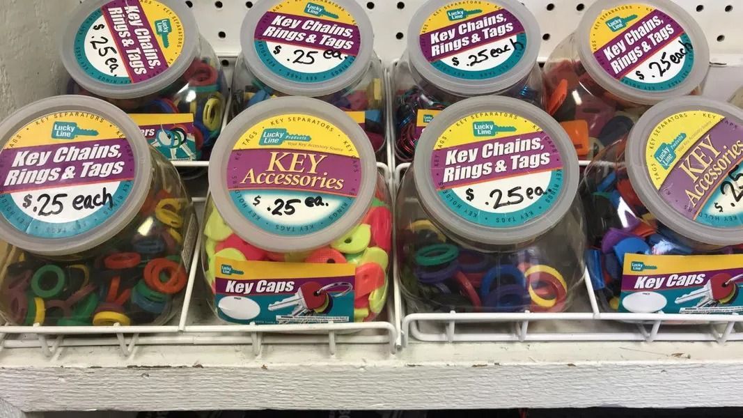 Containers of keychains and accessories, $0.25 each, in a store display.