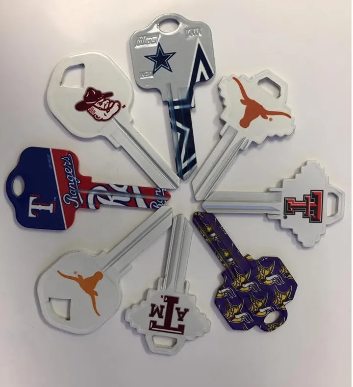 Circle of decorative keys featuring sports team logos, including Cowboys and Longhorns.
