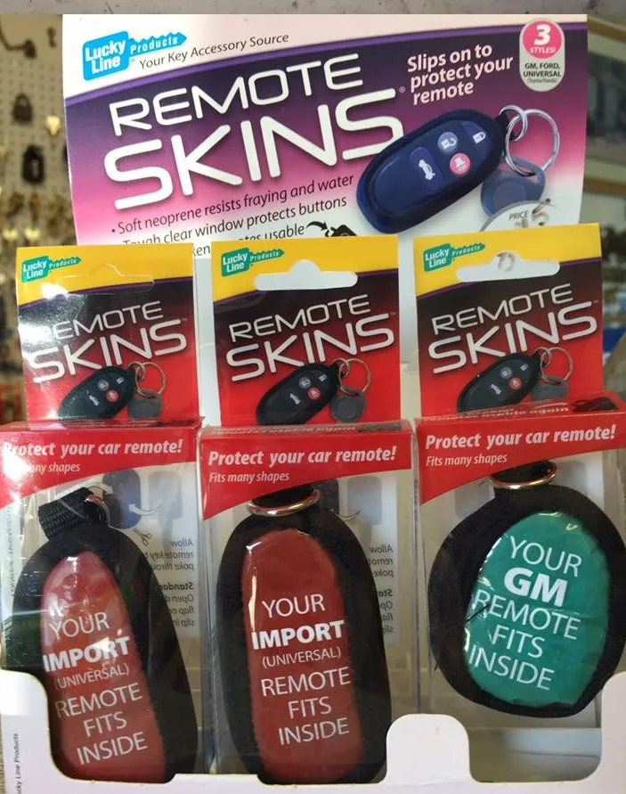 Display of remote skins in red, black, and green packaging, promoting car remote protection.