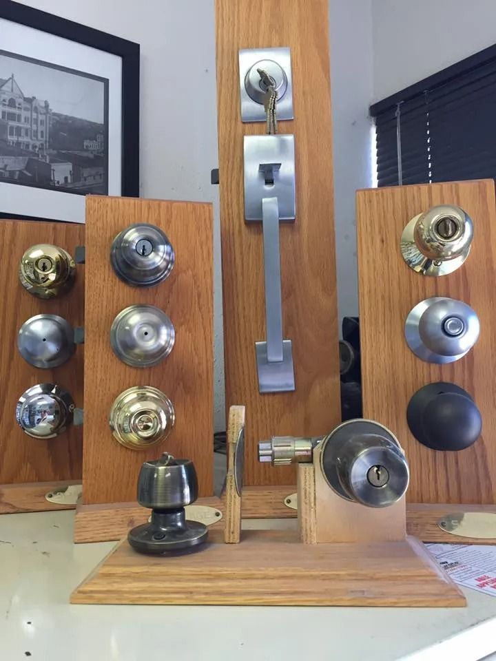 Display of door knobs on wooden boards, various styles and finishes, in a store setting