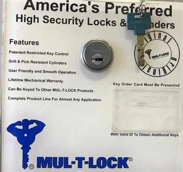 Mul-T-Lock lock display card with key and lock cylinder, white background, blue logo and text