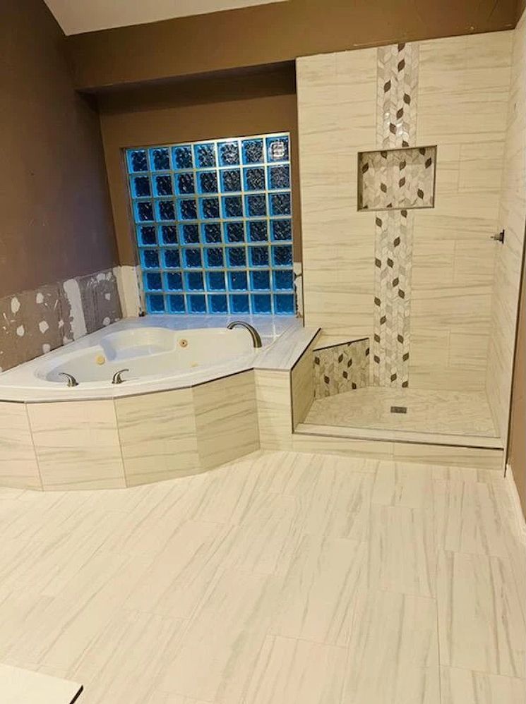 A bathroom with a jacuzzi tub and a walk in shower.