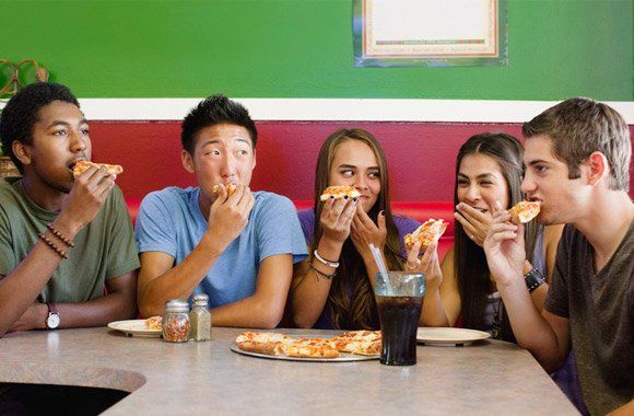 Group of friends enjoying pizza