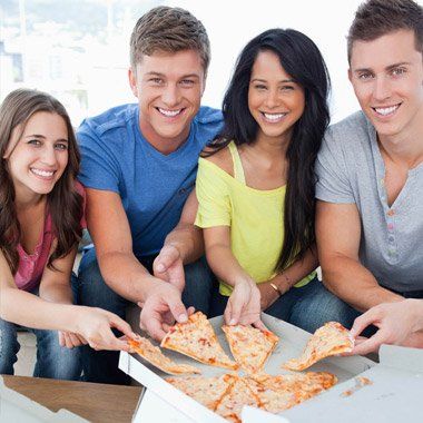 A group of friends eating delivered pizza