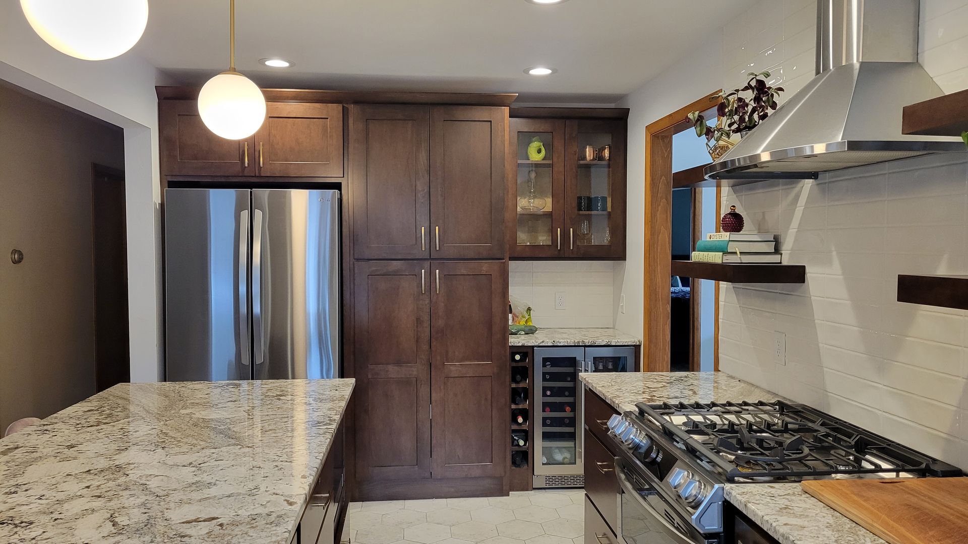 Kitchen with granite countertops, stainless steel appliances, and dark wooden cabinets.