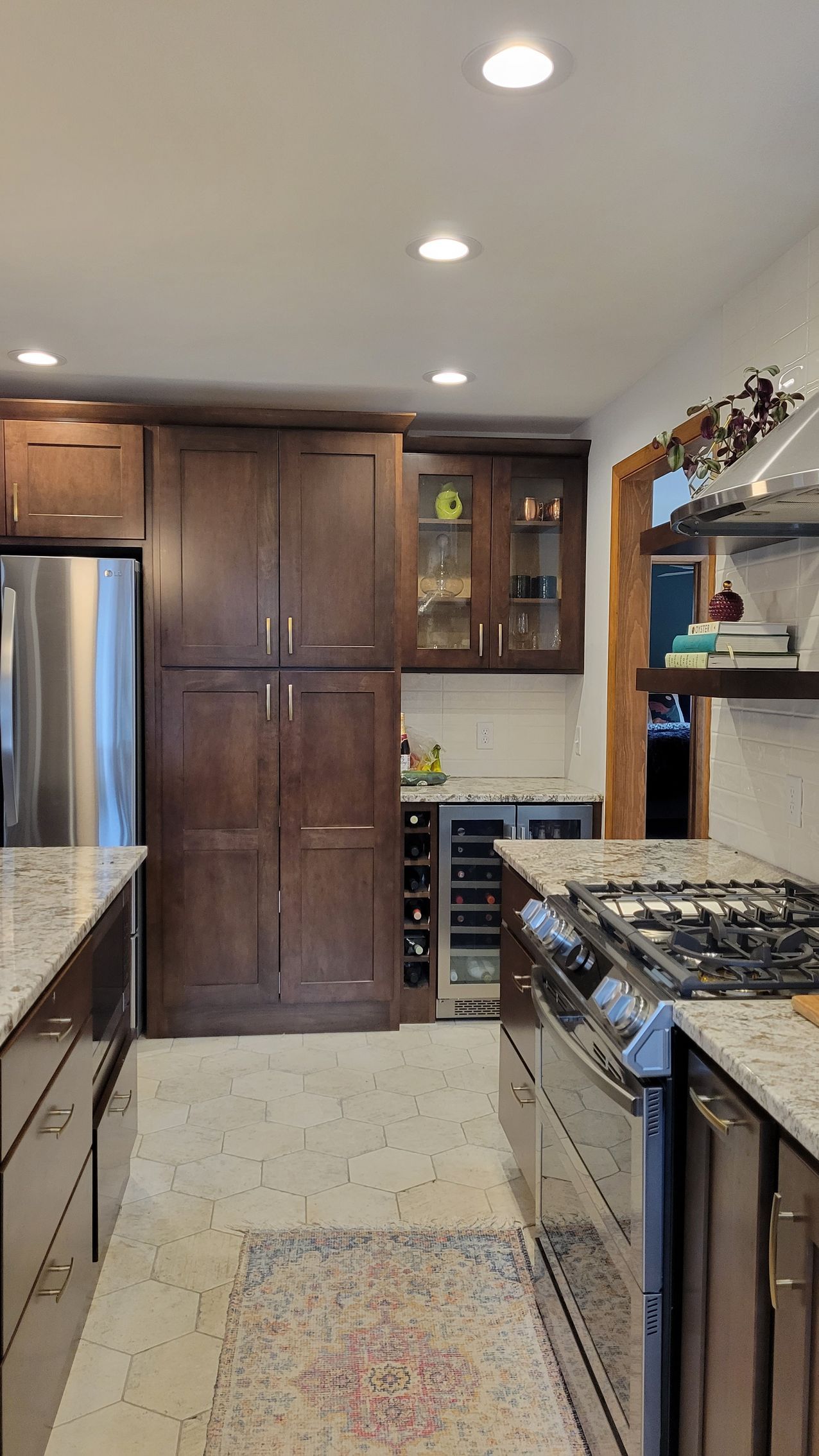 Kitchen with brown cabinets, stainless steel appliances, and granite countertops.