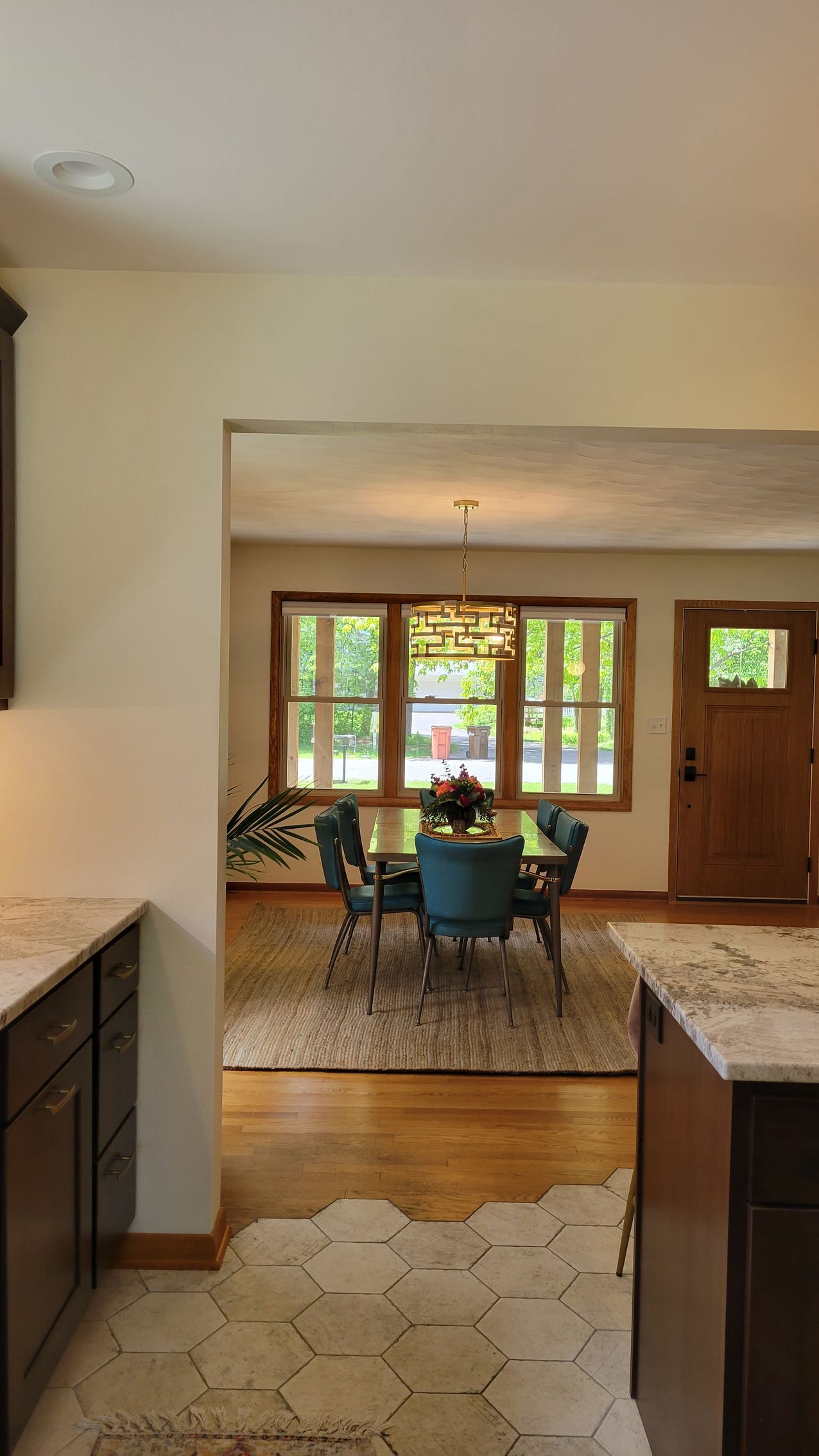 View from kitchen doorway into dining room with table and chairs.