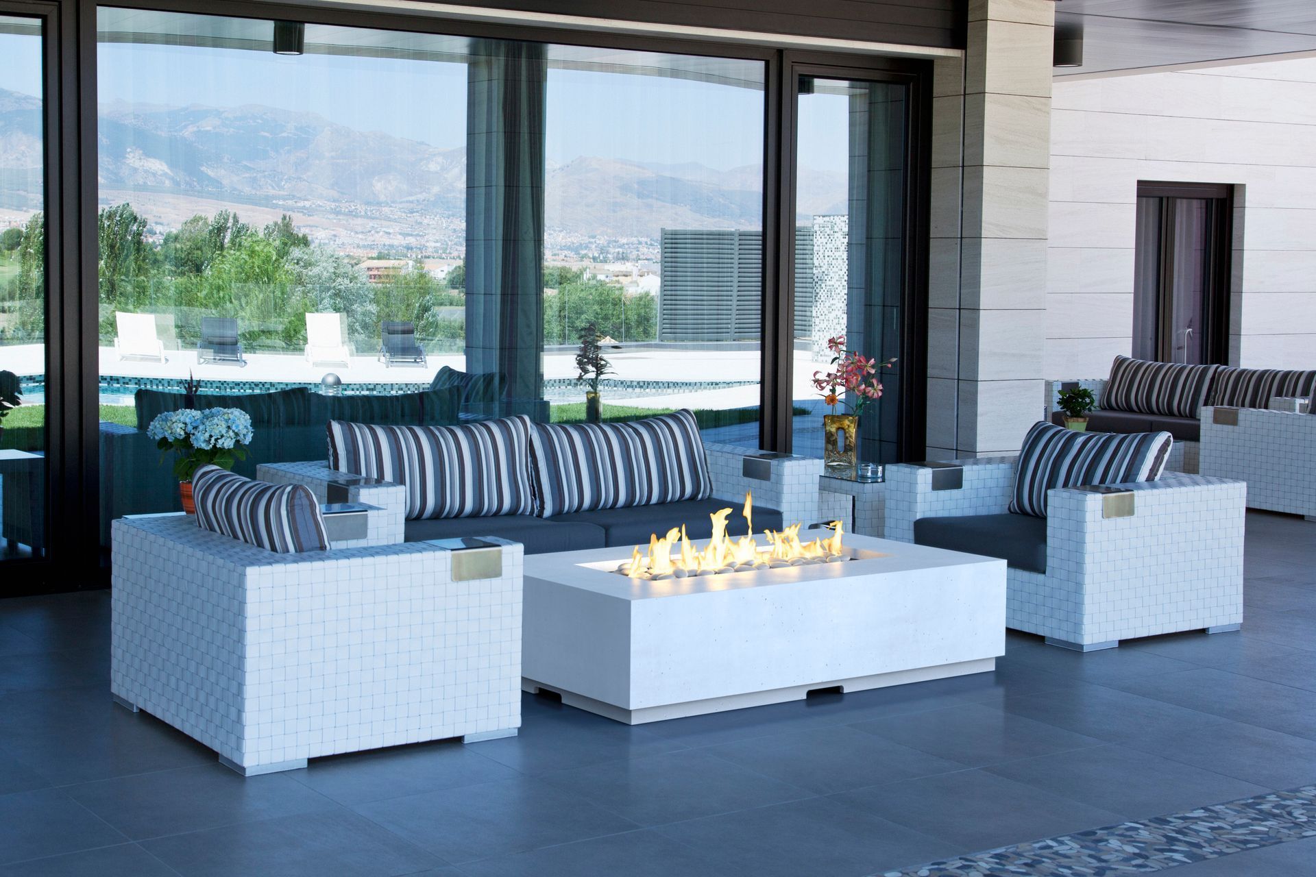 Modern patio lounge with white wicker sofas