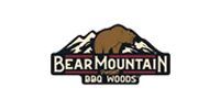 The logo for bear mountain bbq woods has a bear on top of a mountain.