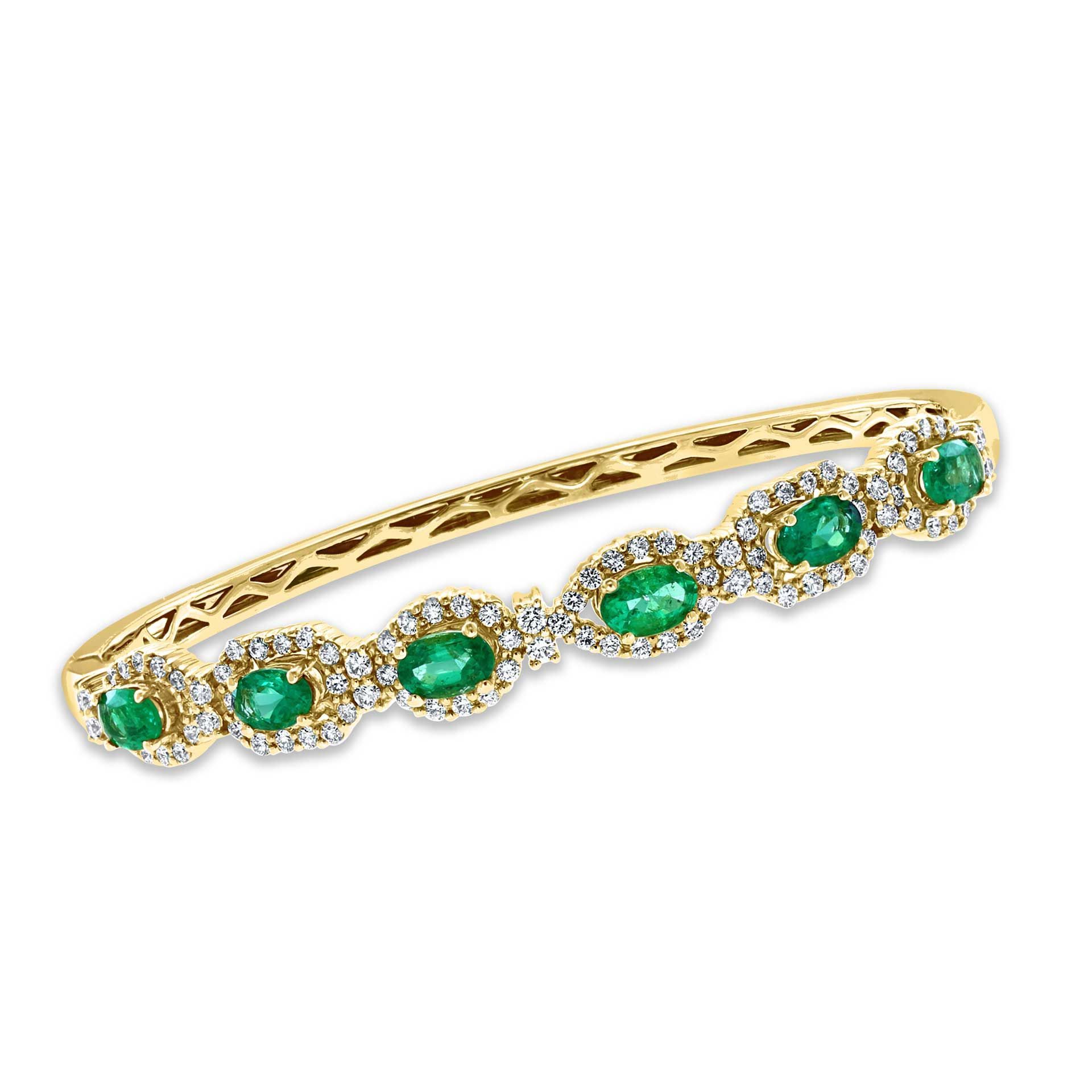 Gold band with green gemstones and diamonds in a curved design
