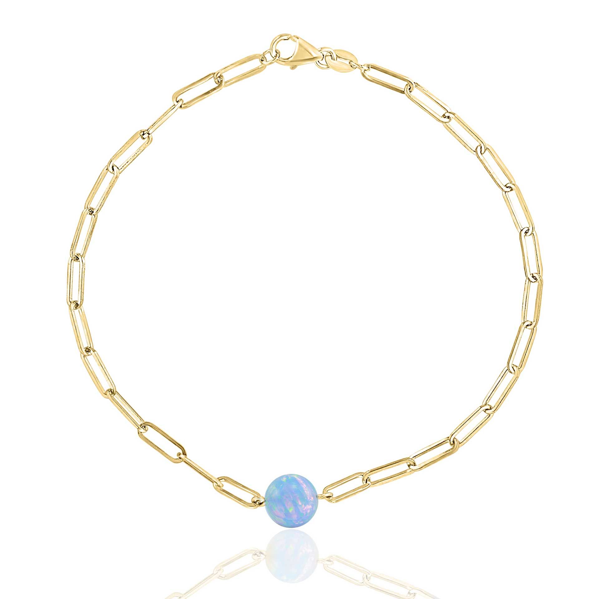 Gold chain bracelet with a round blue opal charm at the clasp