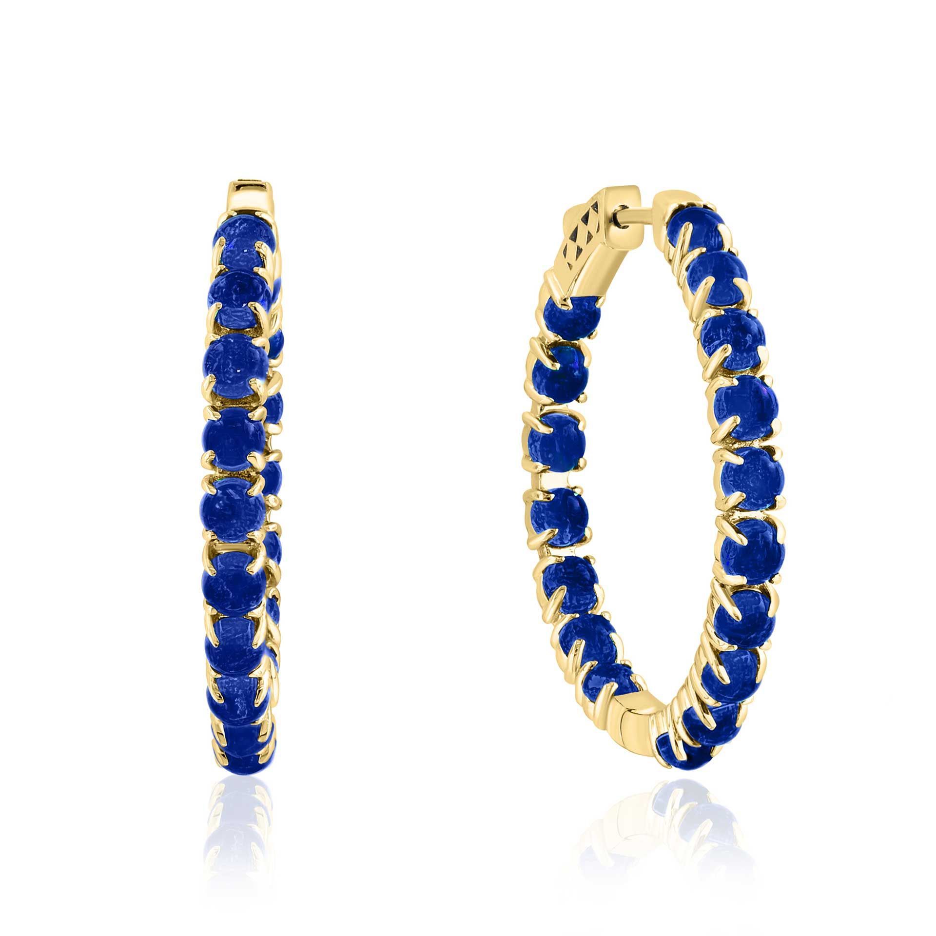 Gold hoop earrings with blue gemstones on a white background