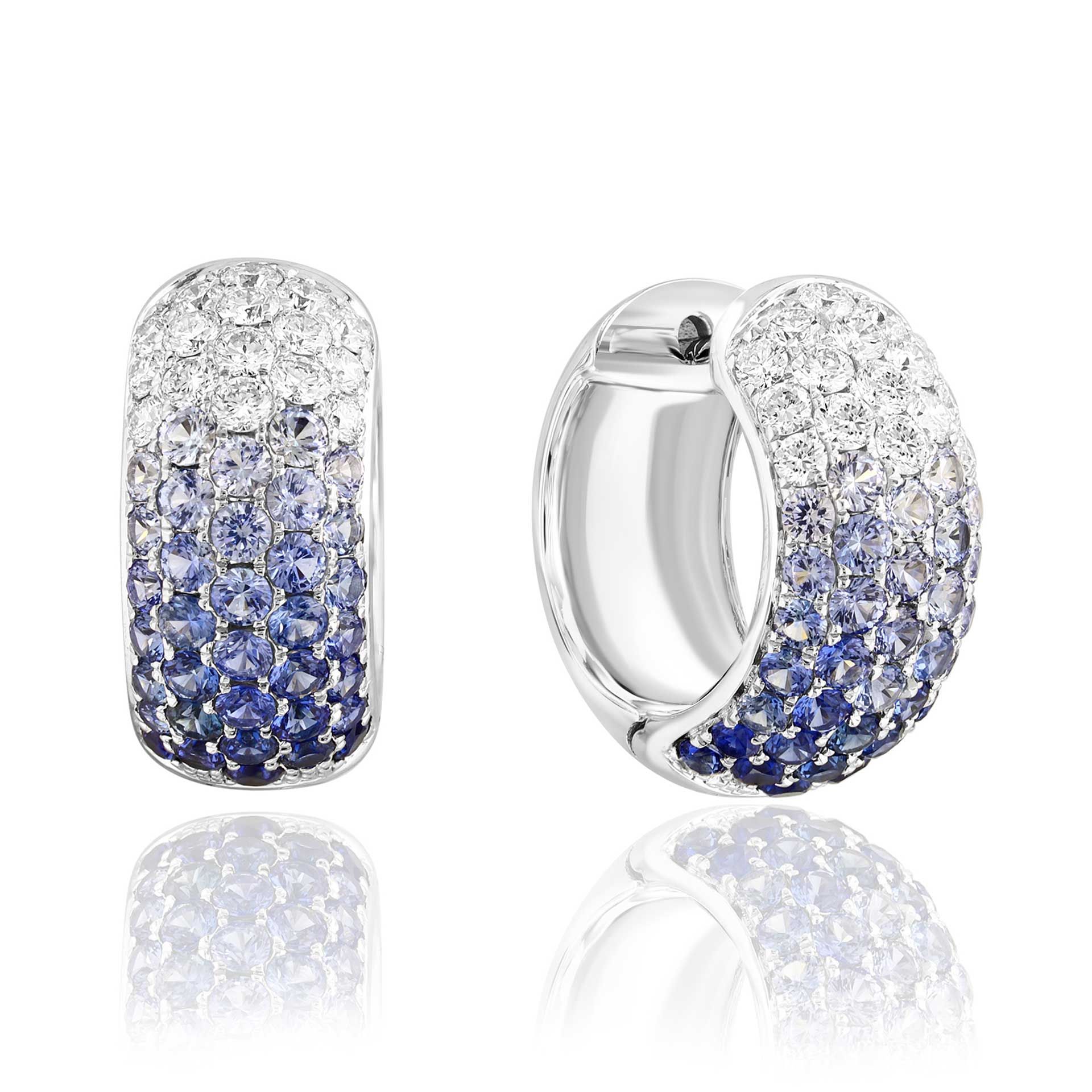 Silver hoop earrings with white, blue, and purple gemstones on a white background