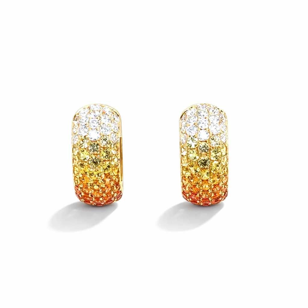 Pair of gold and orange sparkling rectangular stud earrings on a white background