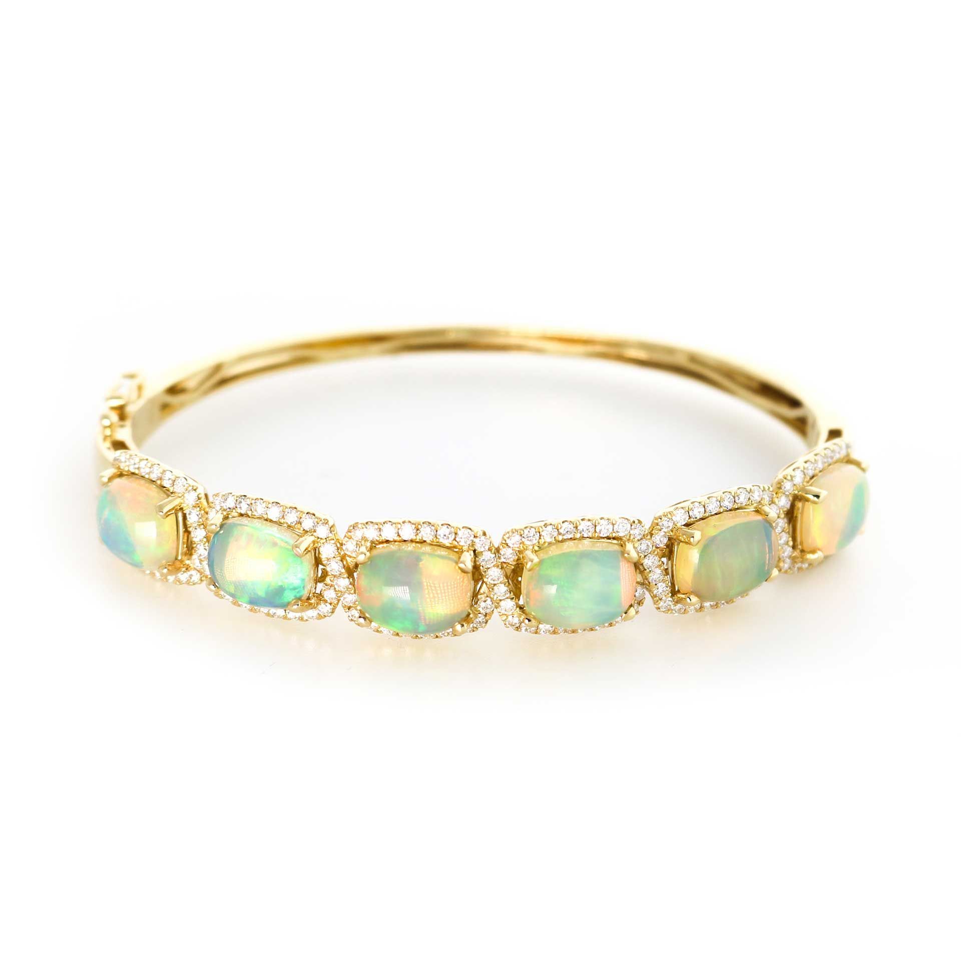 Gold bracelet with five pale green opal-like stones on a white background