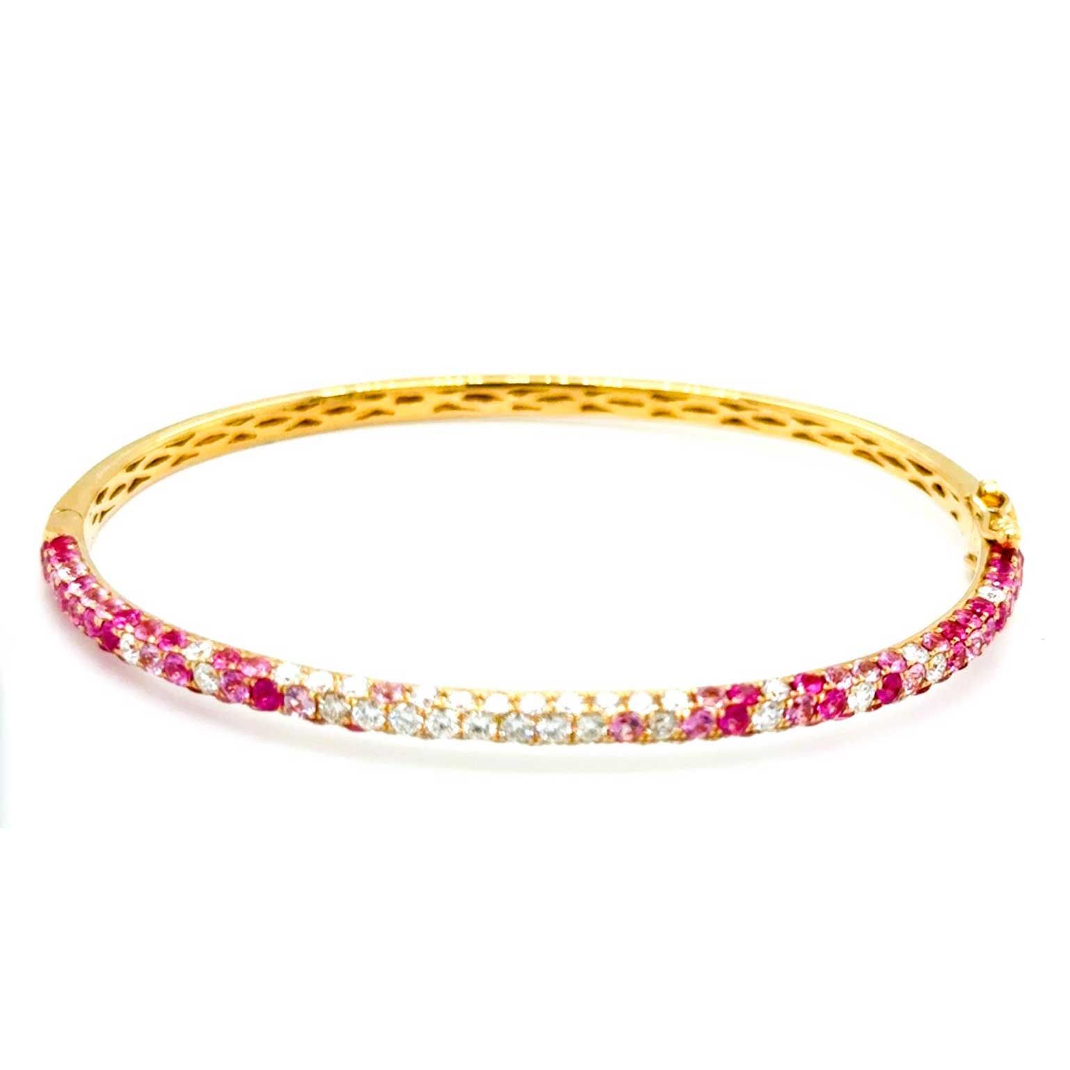 Pink and white gemstone tennis bracelet on a gold band