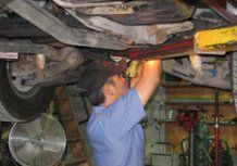 Technician repairing a vehicle