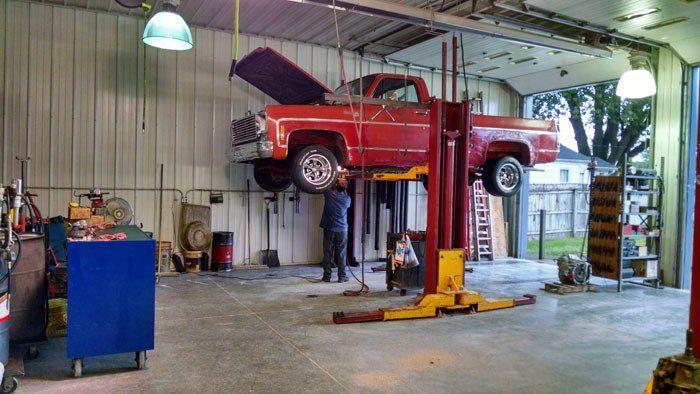 Pickup truck lifted for repair
