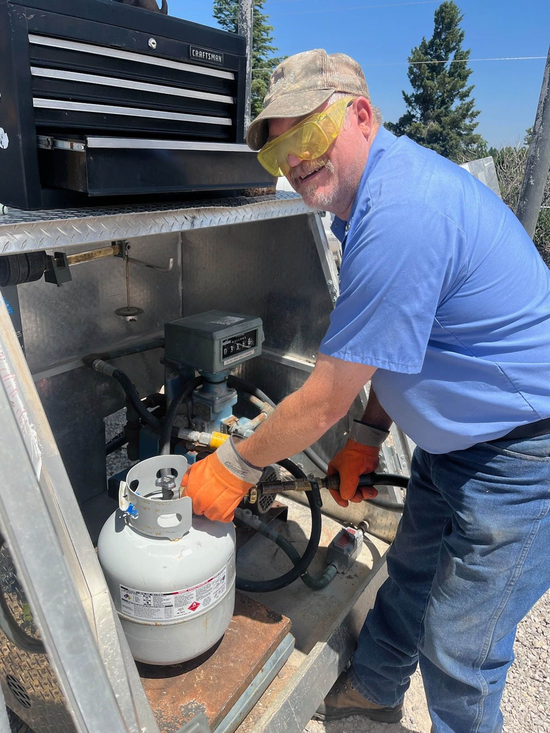 A man standing in front of a Scotty's propane truck