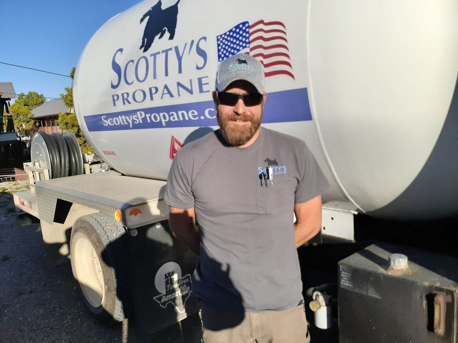 A man standing in front of a Scotty's propane truck