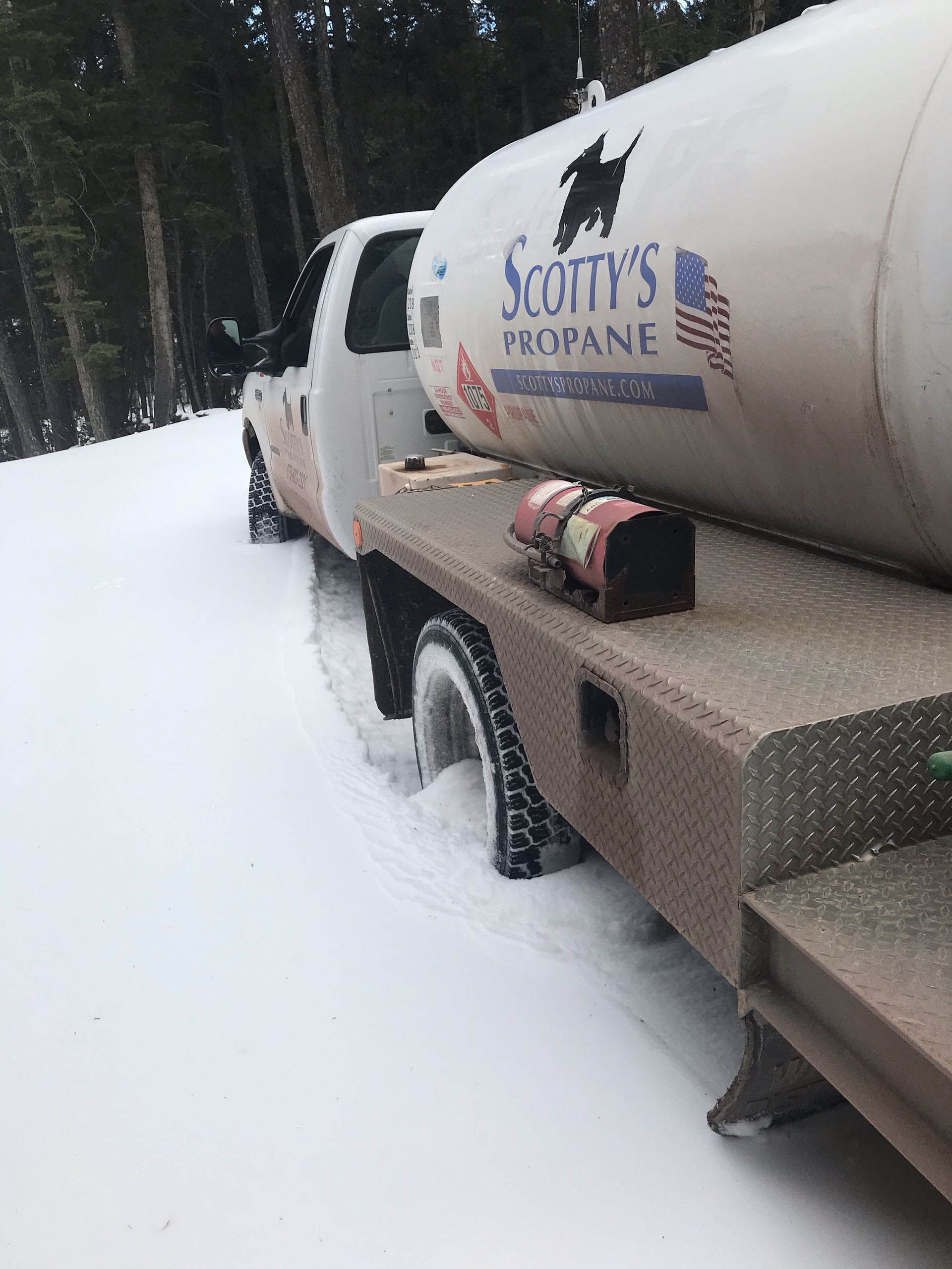 A Scotty's Propane truck is parked in the snow.