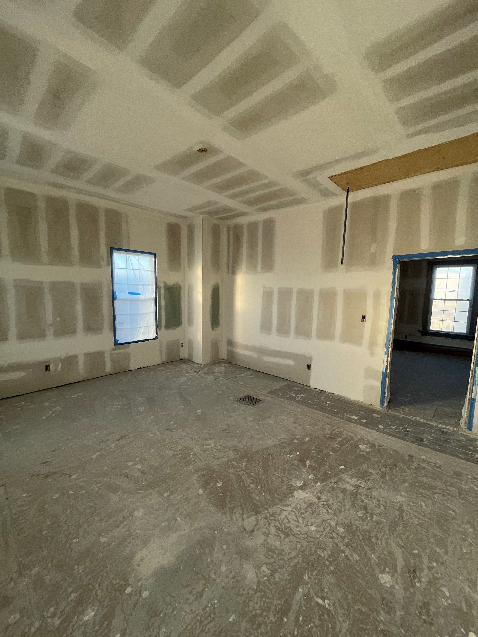 An empty room with drywall on the walls and ceiling