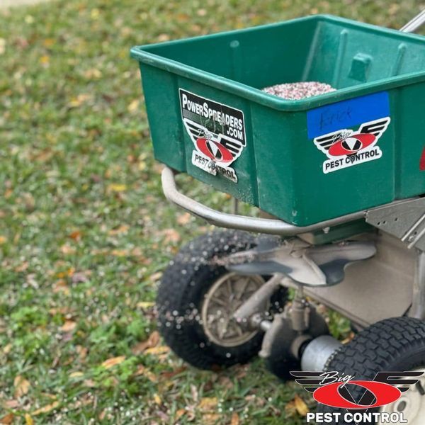 A green spreader that says pest control on it