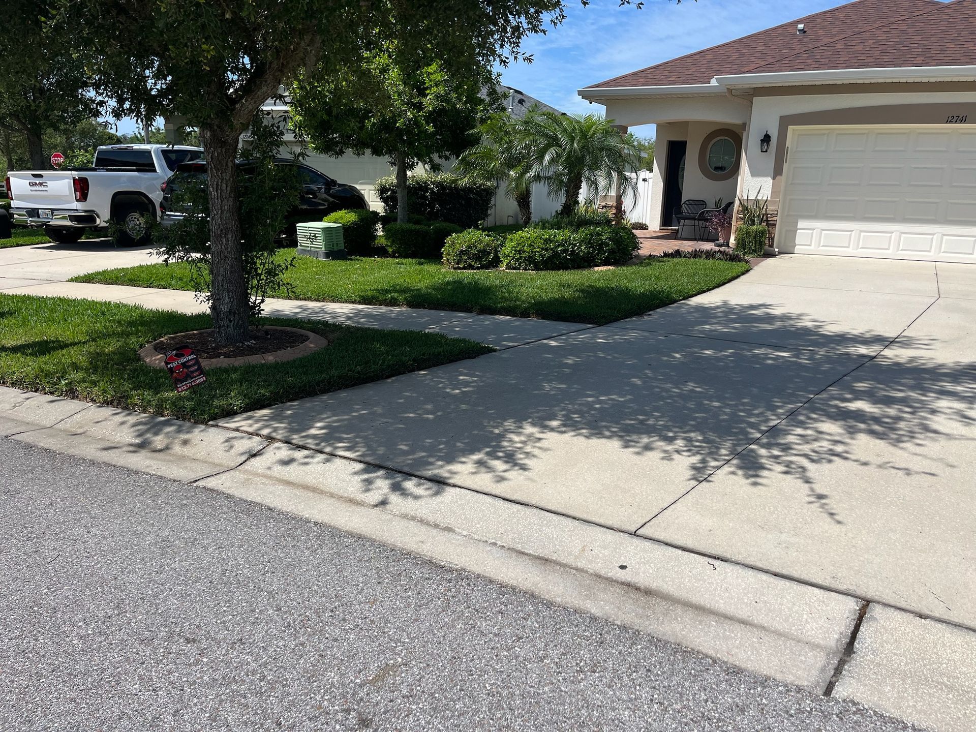 A white house with a truck parked in front of it