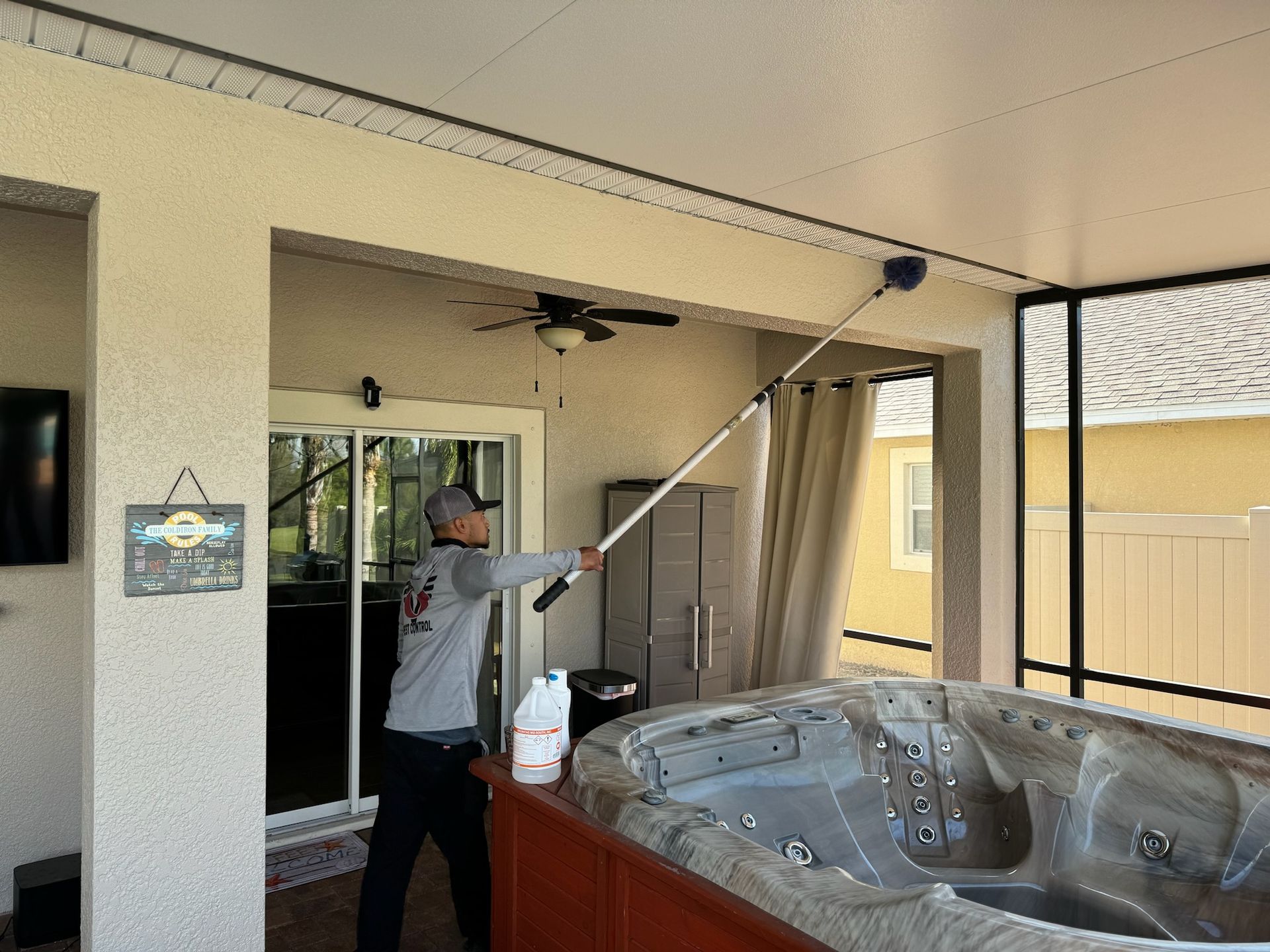 A man is cleaning the ceiling of a hot tub.