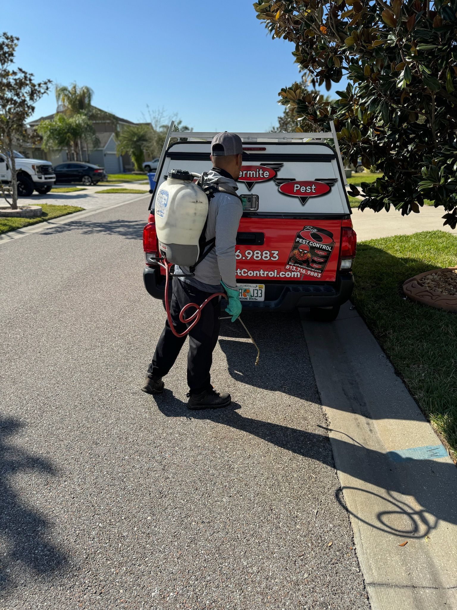 A man is spraying a truck with a sprayer.