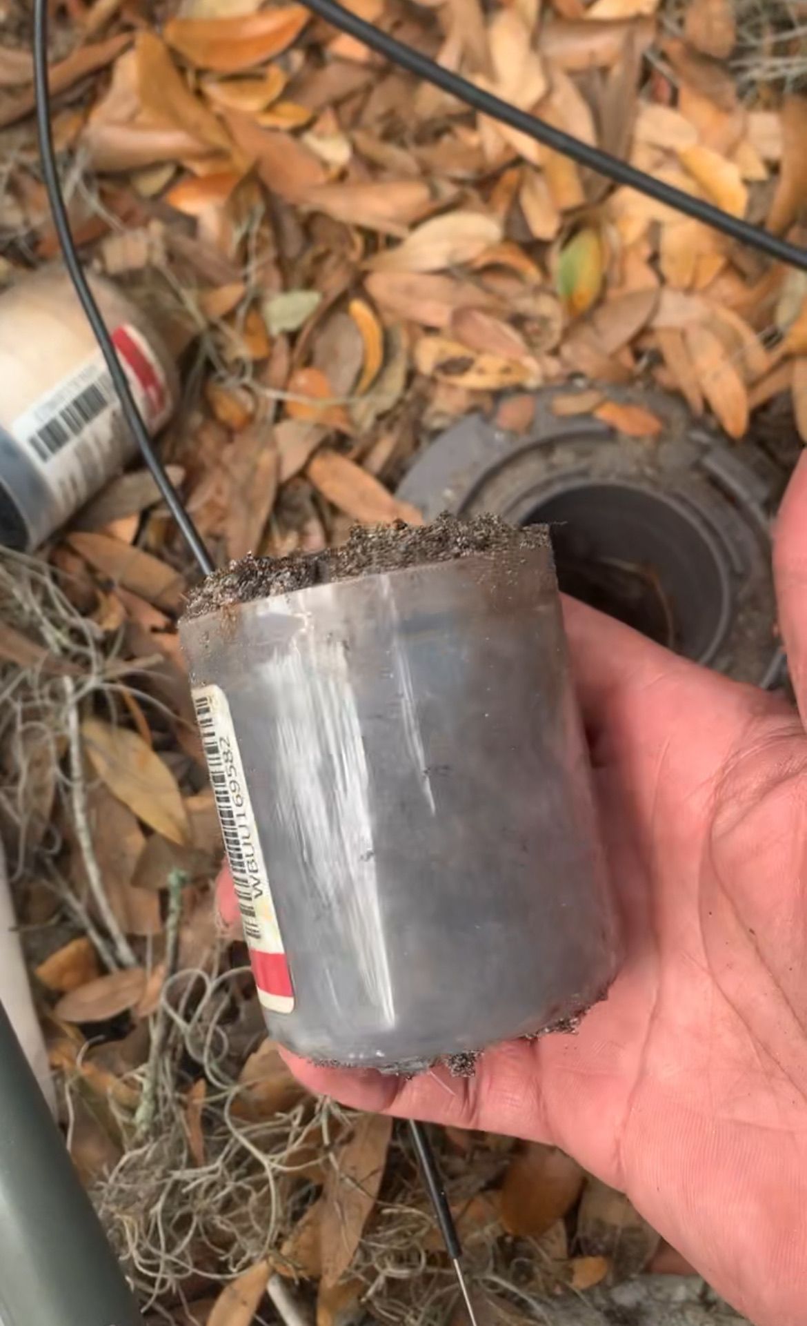 A person is holding a piece of metal in their hand.