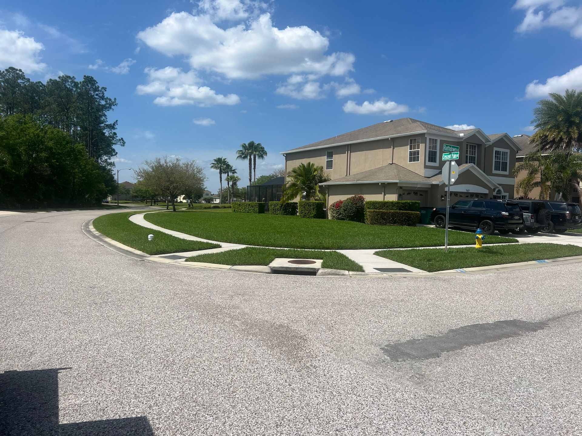 A house with a green street sign in front of it