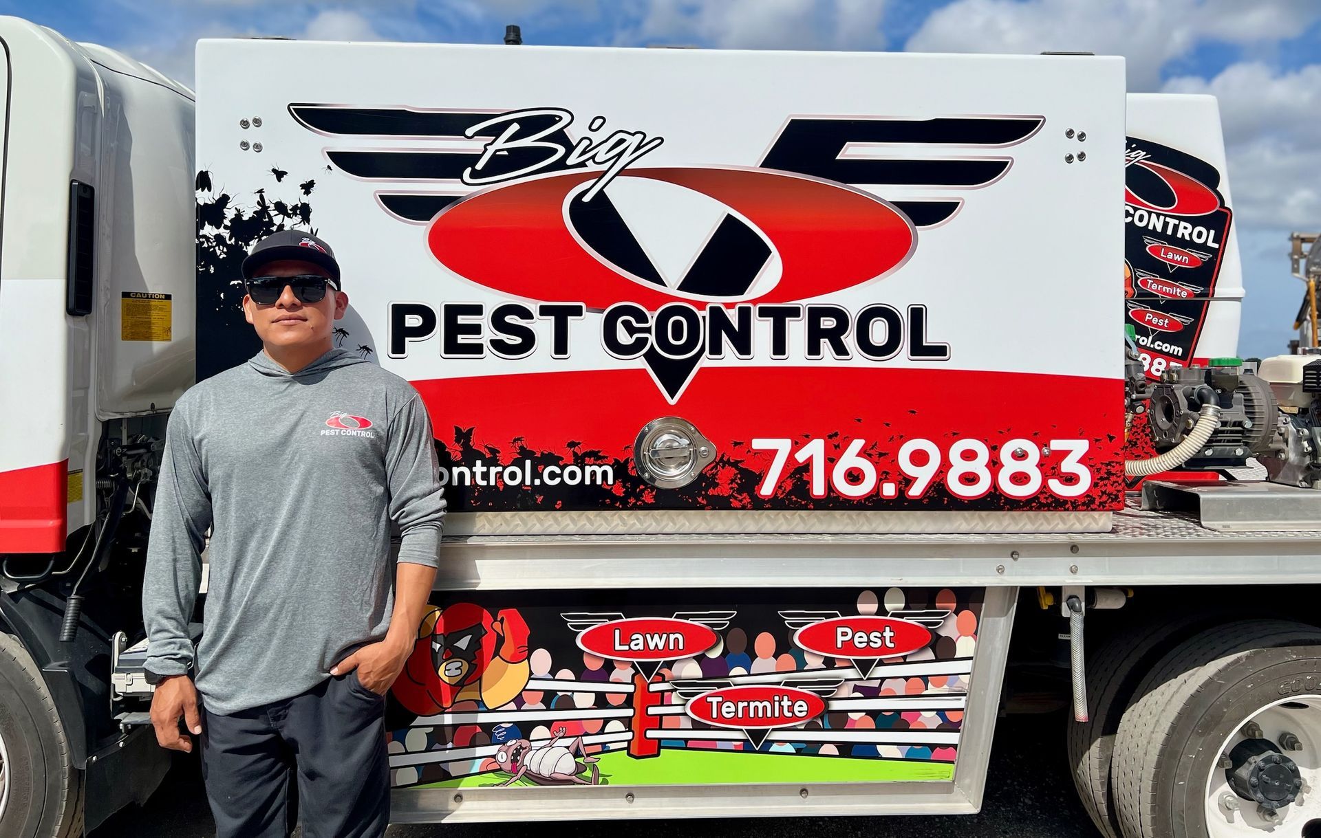 A man is standing in front of a pest control truck