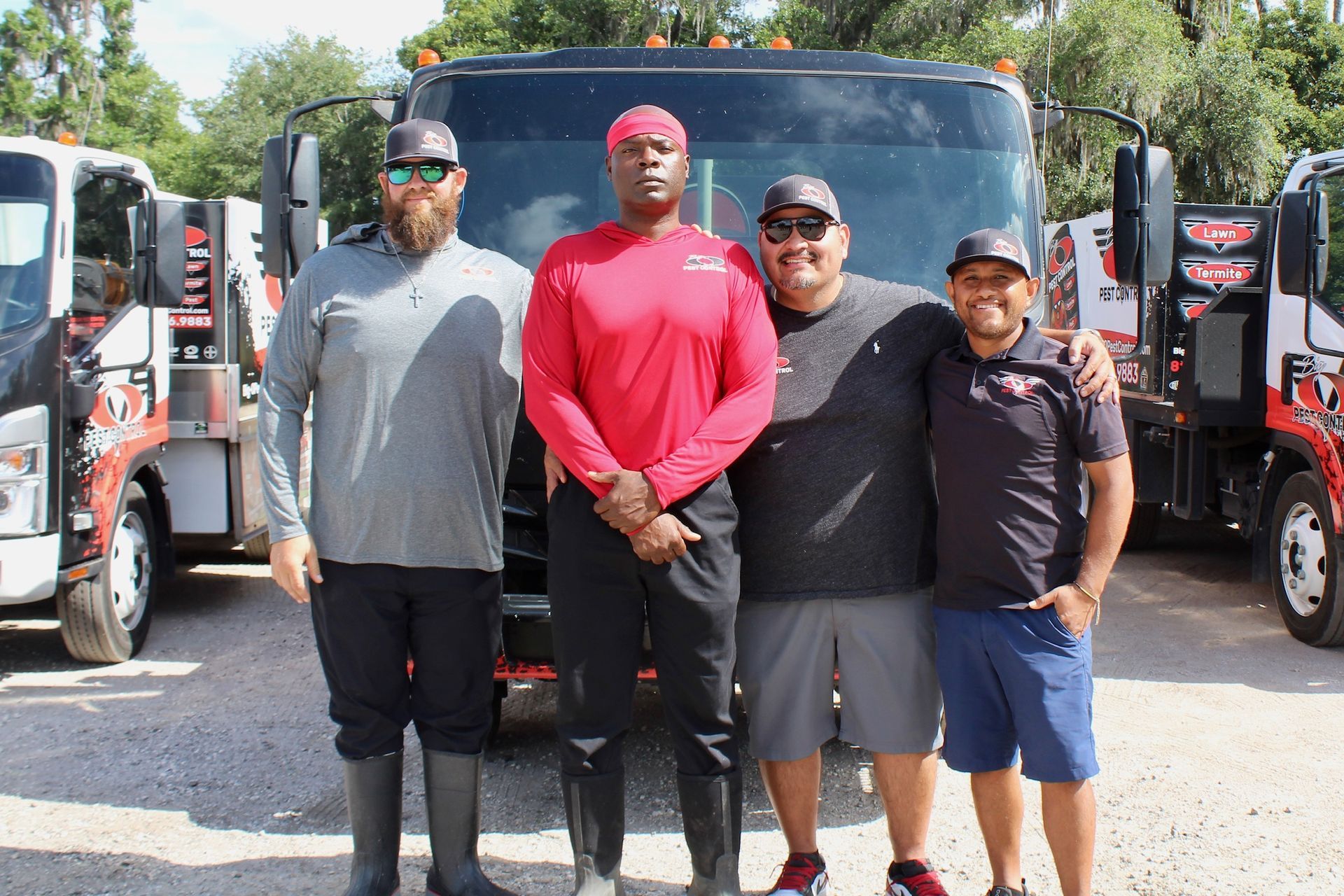A group of men are posing for a picture in front of a tow truck.
