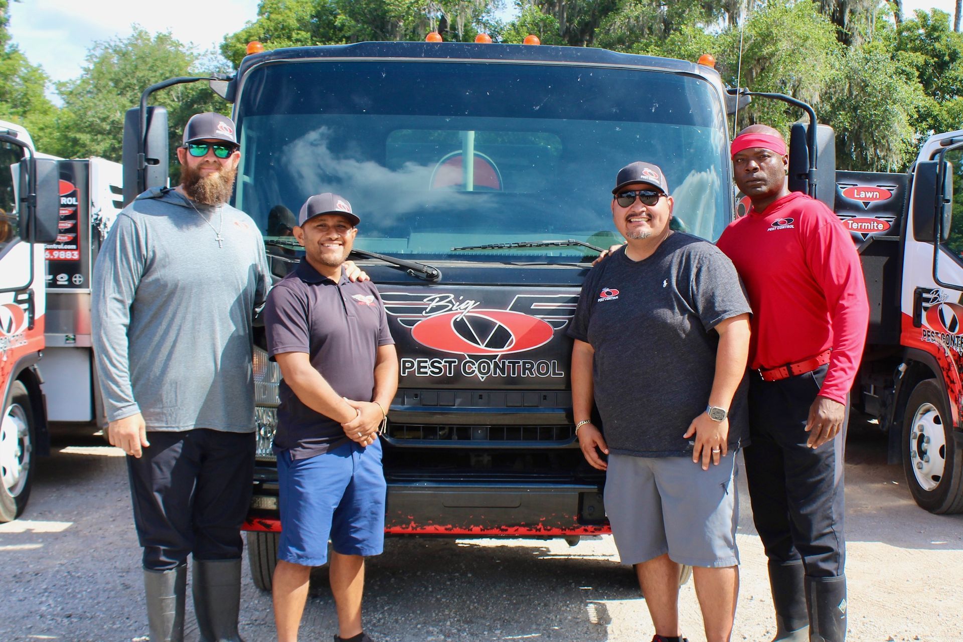 A group of men are standing in front of a truck.