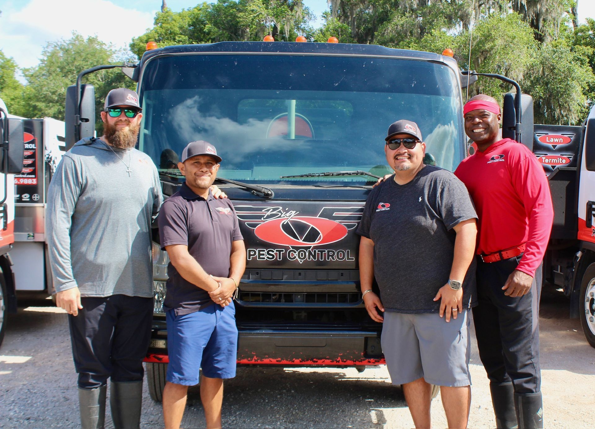A group of men are standing in front of a truck.