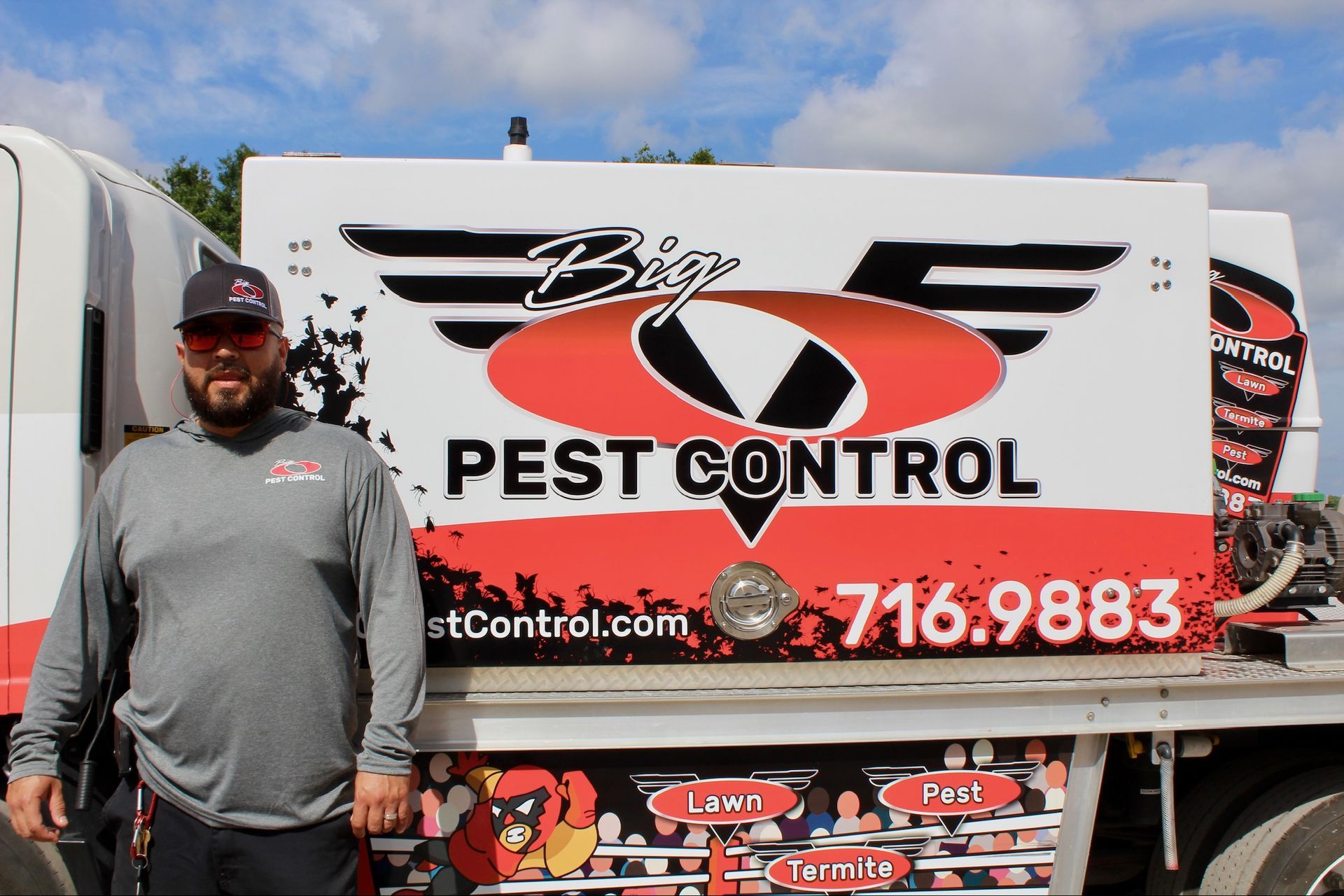 A man is standing in front of a pest control truck.