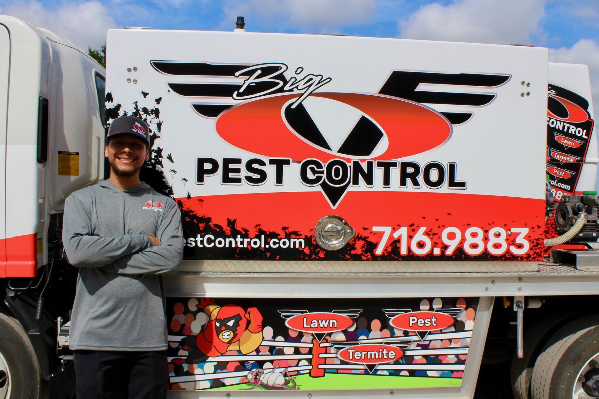 A man is standing in front of a pest control truck