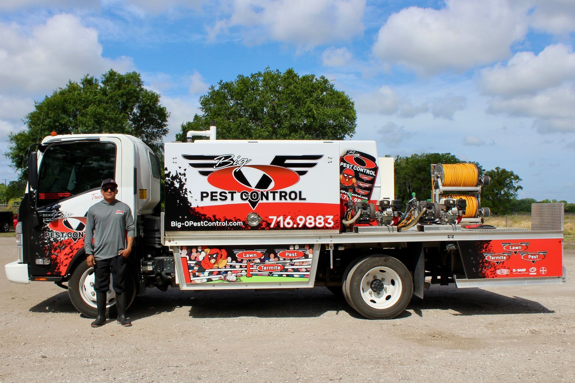 A man standing next to a pest control truck
