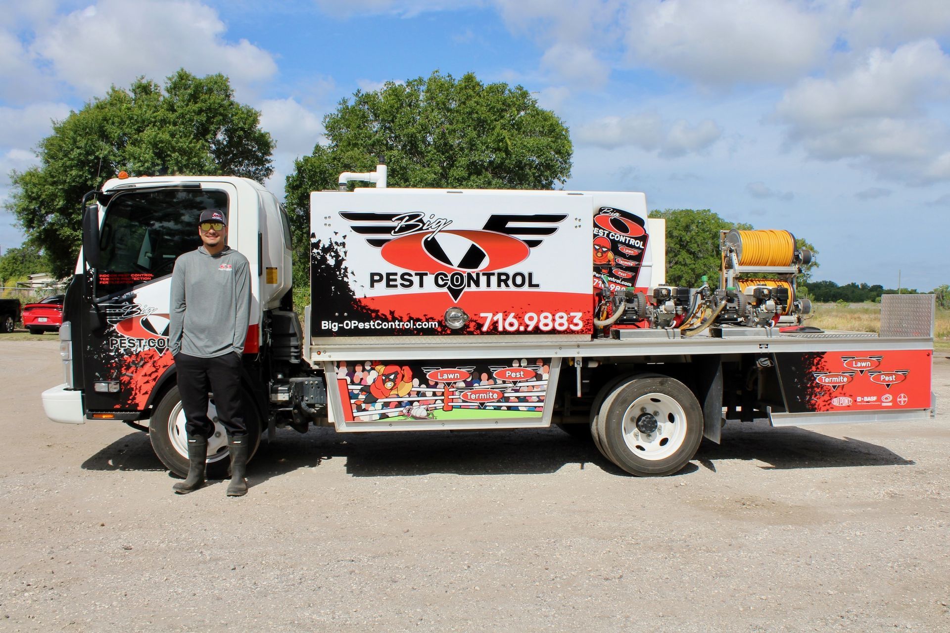A man is standing in front of a pest control truck