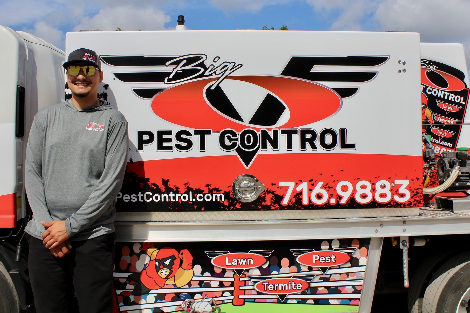 A man is standing in front of a pest control truck