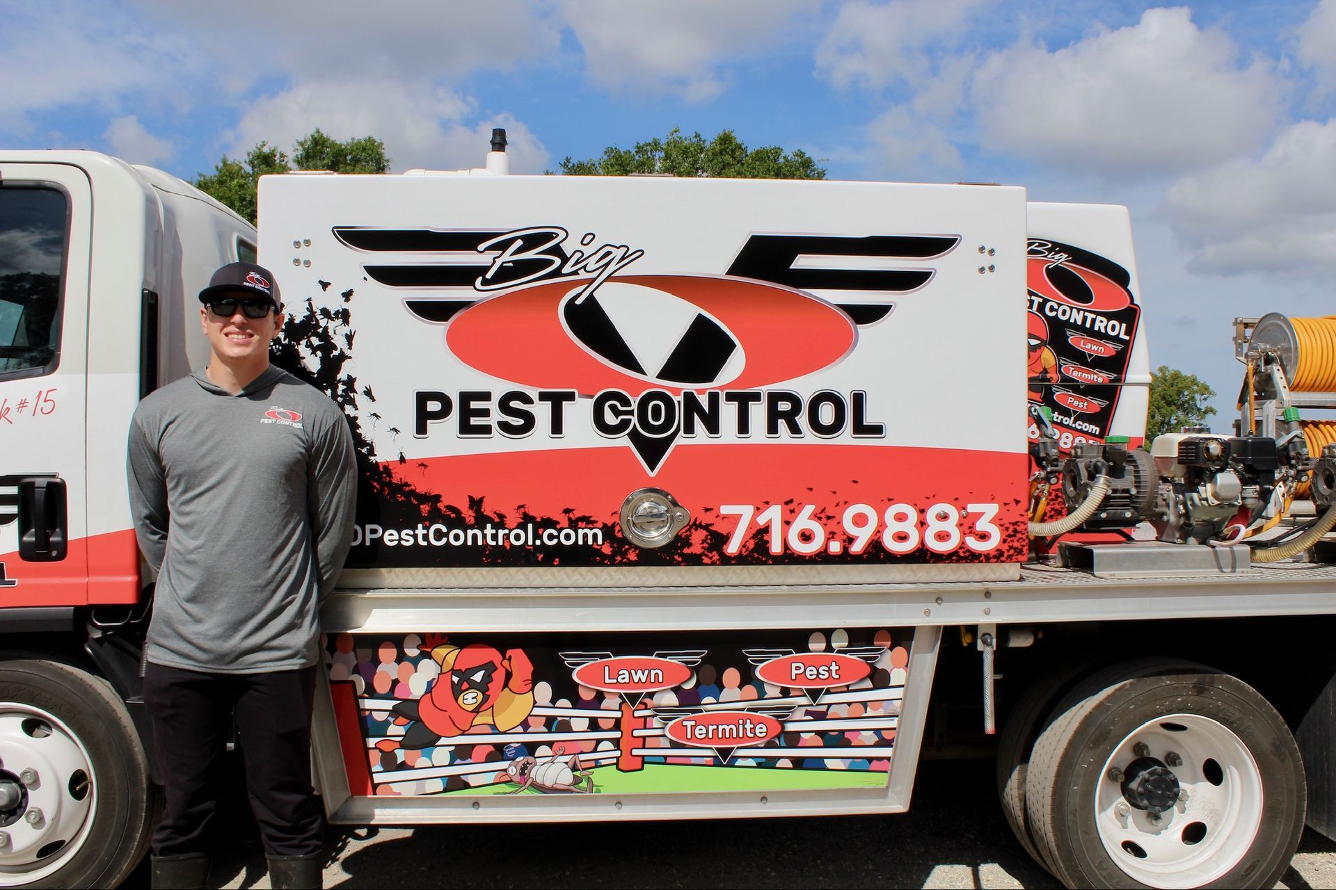 A man is standing in front of a pest control truck