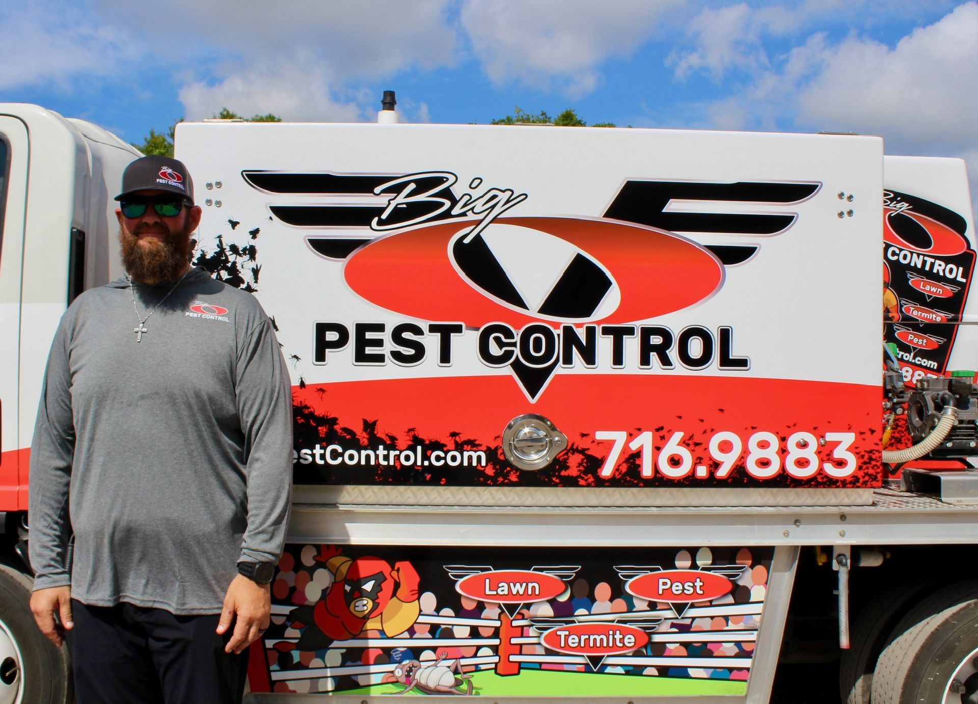 A man is standing in front of a pest control truck